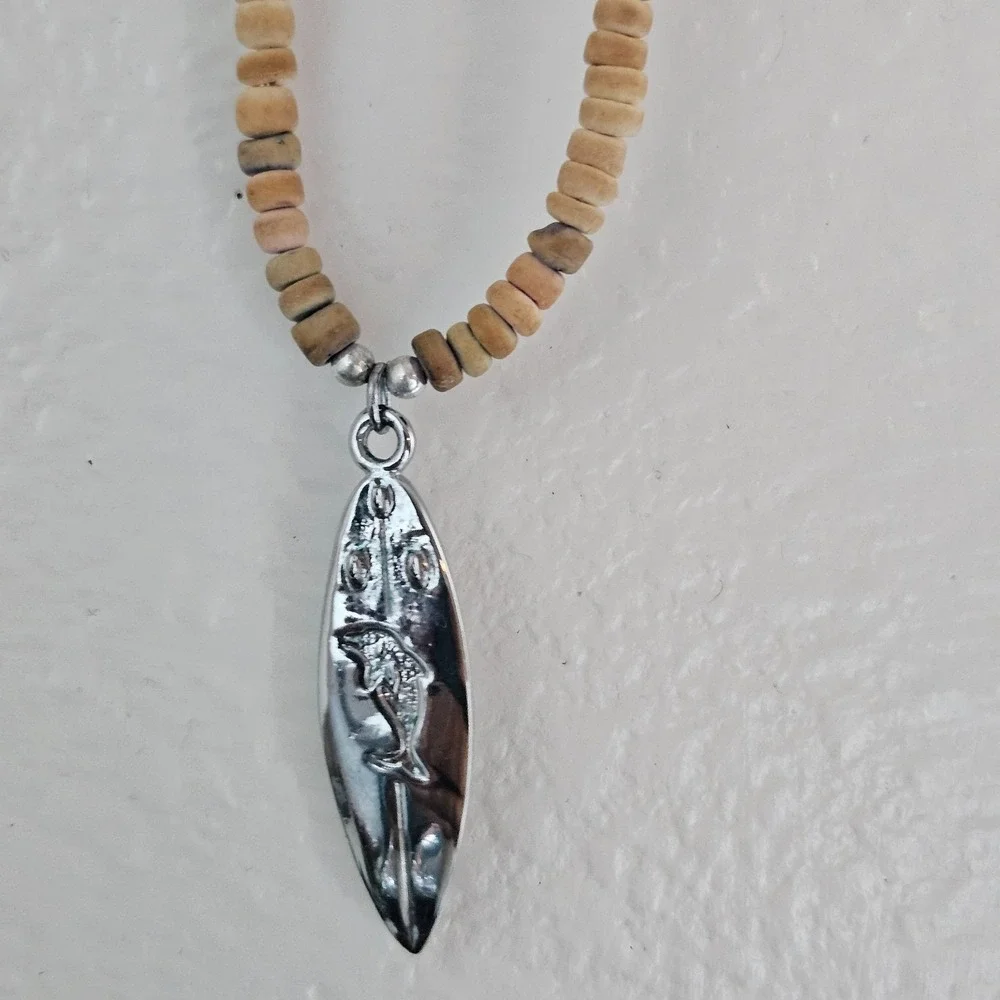 Native Treasure surfboard and coconut bead necklace beachy dolphin pendant